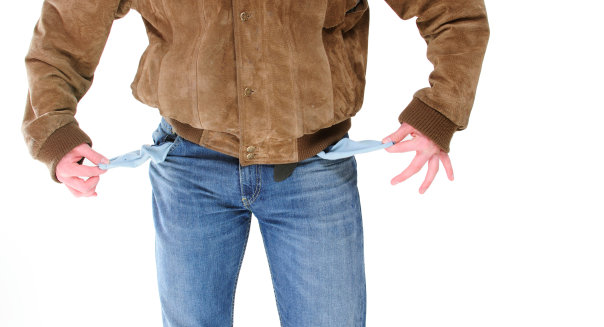 Young adult man, wearing leather jacket, showing his empty pockets
